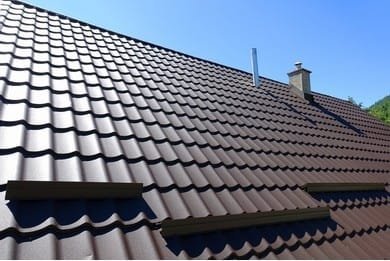 Roofer inspecting storm-damaged roof tiles on a Victorian terrace in Kilburn London